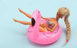 Barbie doll on a pink inflatable flamingo